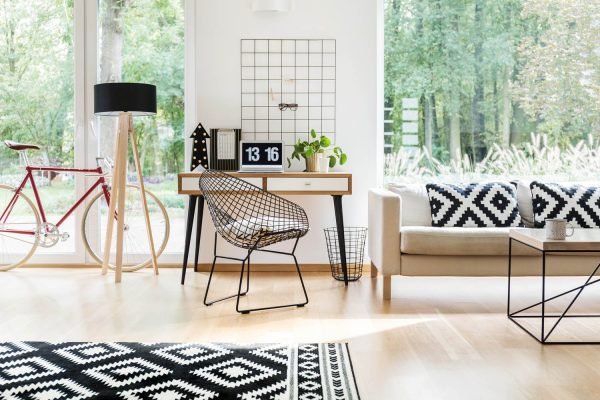 Modern diamond-pattern chair placed at a wooden desk in a stylish home office