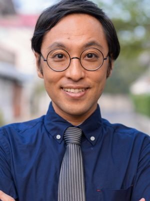 Professional Japanese businessman with arms crossed standing confidently
