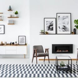 Modern living room with a fireplace flanked by two sleek grey armchairs