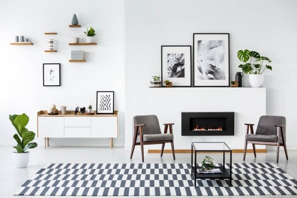Modern living room with a fireplace flanked by two sleek grey armchairs
